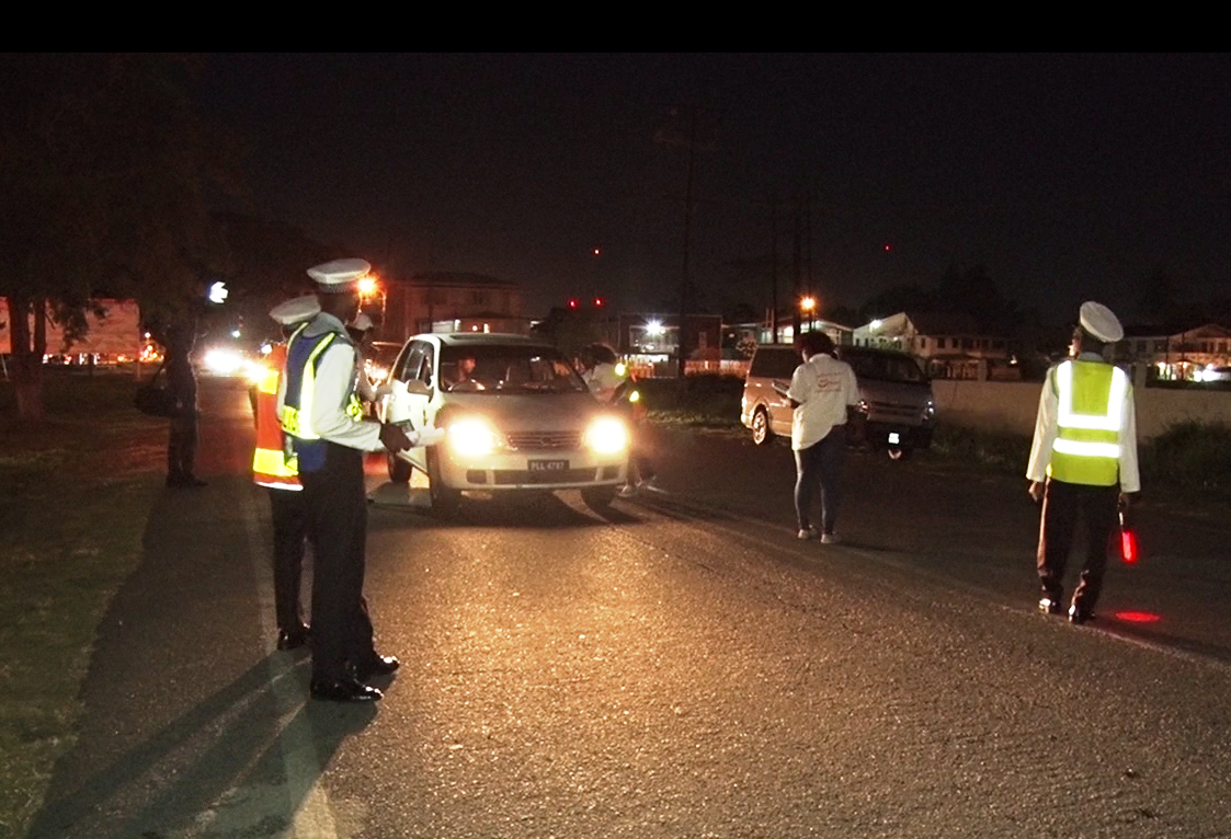 The GNRSC members distributing road safety paraphilia and briefly chatting with drivers